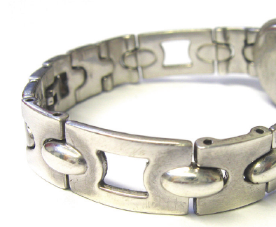 Plated traditional sterling silver watch bracelet showing dark areas of exposed firestain where the bright silver plate has worn away