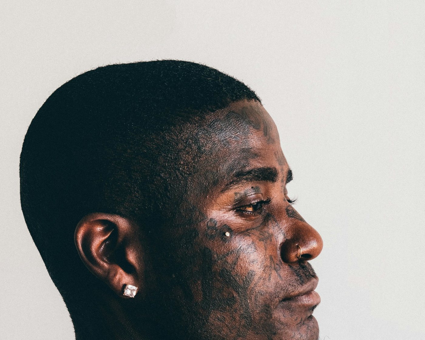 Man wearing a clear stone stud earring