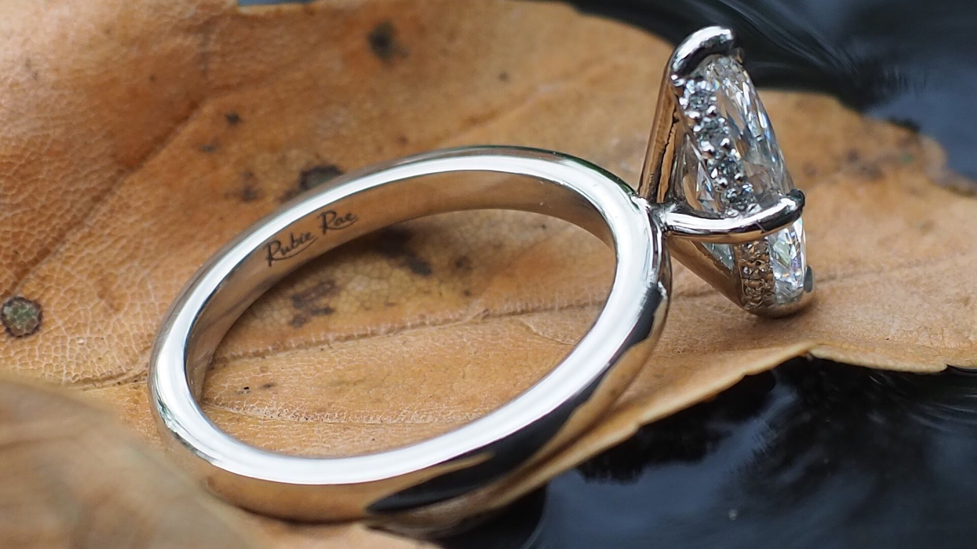 A white metal solitaire ring with a brilliant cut stone
